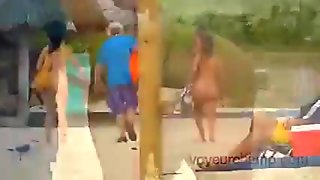 Wives Teasing Nude Beach Voyeurs & Gives One A Handjob!