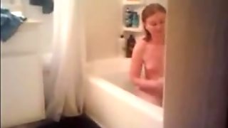 Redhead babe gets caught showering on hidden camera